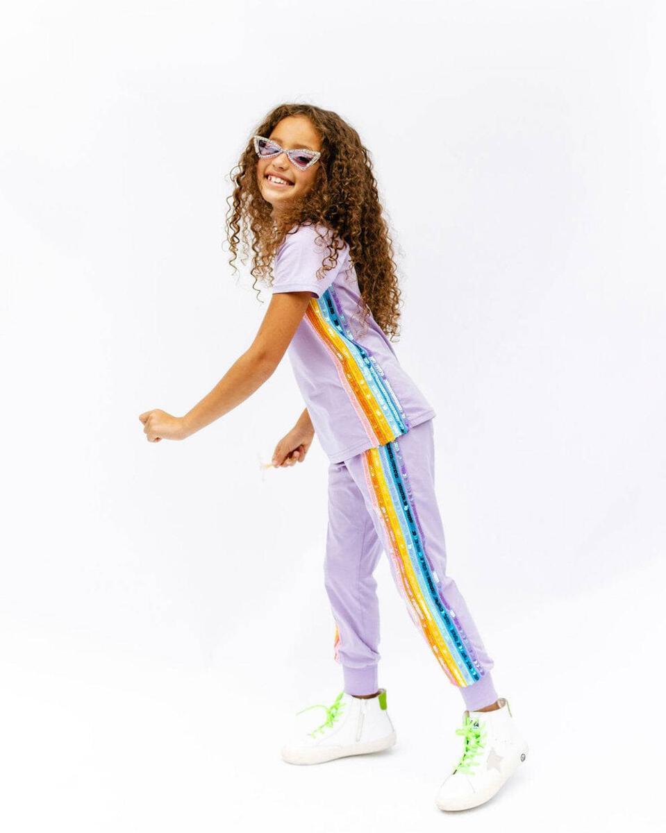 Lola + The Boys Lavender Rainbow Sequin Jogger Set. Dazzle them with this comfy and stylish set that will have them ready to take on the day in a trendy look. Includes soft, lightweight lavender tee and jogger with sequin rainbow aligning the sides. An easy go-to outfit that's sure to bring a smile and some serious sparkle!