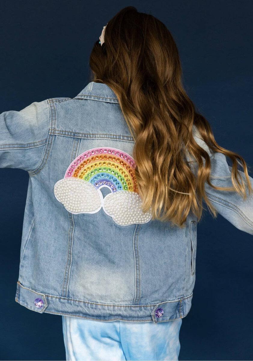 Lola + The Boys. Turn heads with this one-of-a-kind Rainbow Pearl Denim Jacket! With a light denim wash and detailed with a rainbow pearl patch on the back and rainbow buttons, this jacket will add some serious color and pizazz to any outfit. So don your outfit with the perfect jacket and make a statement!