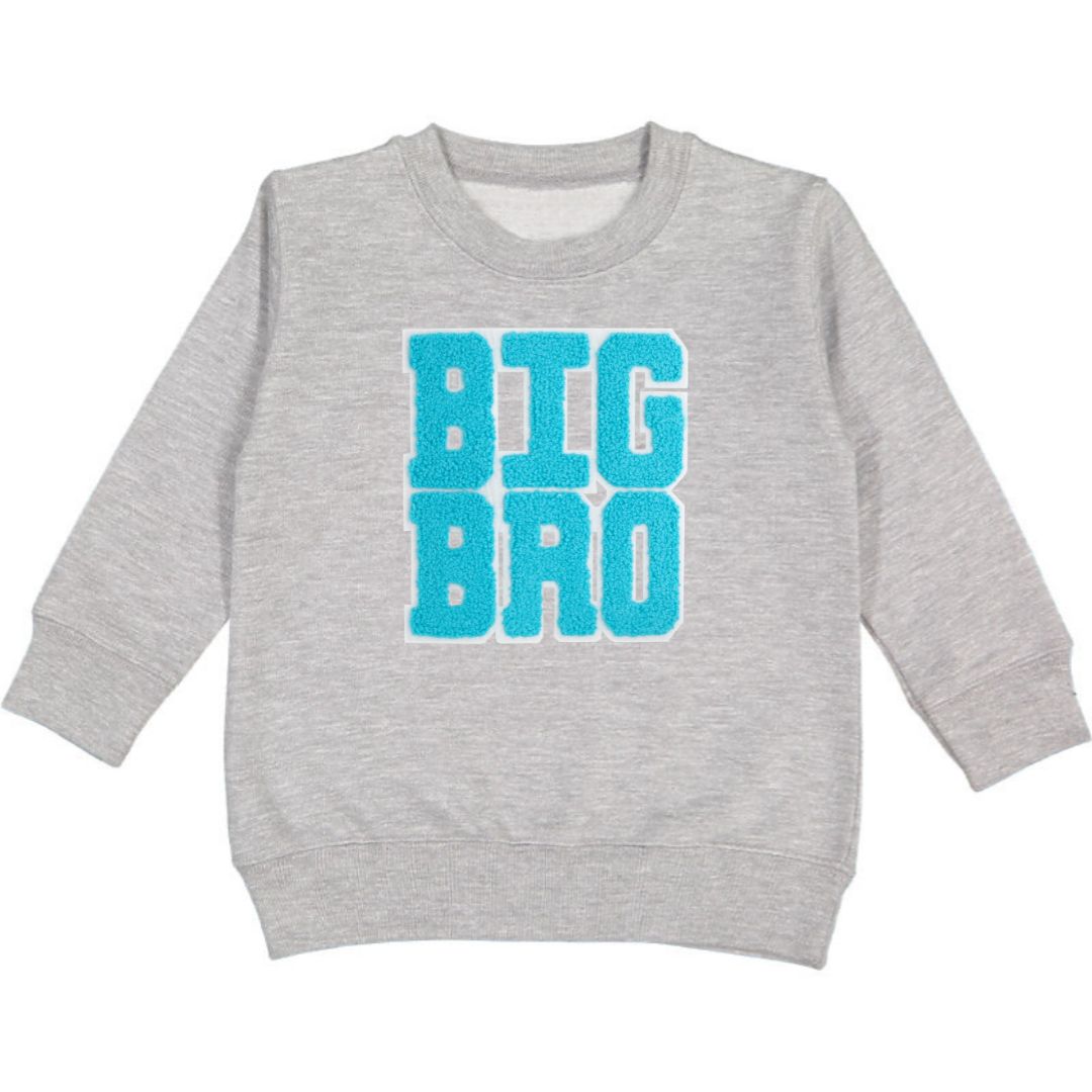 This Sweet Wink Big Bro Patch Sweatshirt is a fun and cute sweatshirt for any big brother! Features grey crewneck with blue chenille patch letters. Tagless inside neck label for itch-free wear. Toddler Unisex fit. Each sweatshirt is hand pressed with love. 60% Cotton, 40% Polyester Fleece. Machine washable; wash inside out, lay flat to dry. Women owned, mama owned.
