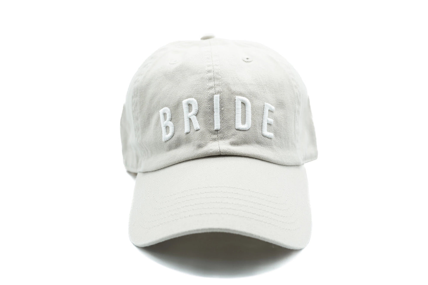 100% cotton. Adjustable back closure. Letters are hand-sewn.