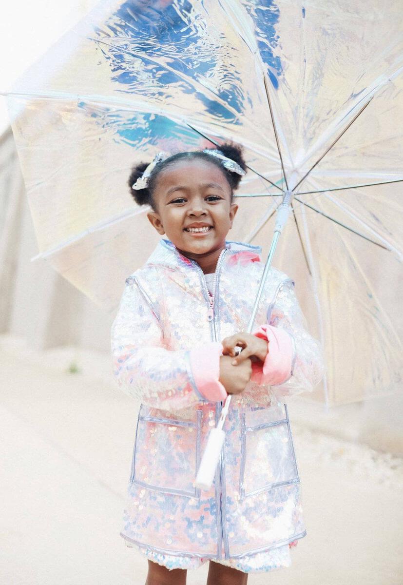 Lola + The Boys. Let your little one sparkle like a diamond in the rain with this Paillette Magic Rain Jacket from Lola + The Boys! With colorful and cute designs that'll glisten with each raindrop, this is the perfect jacket for any rainy day adventures. 