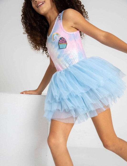 Lola + The Boys. Let your little one twirl and spin like the rainbow treat that they are with this Lola + The Boys Tie Dye Rainbow Cupcake Tutu Dress! A one-of-a-kind dress featuring a tie-dye cupcake patch and a blue tulle tutu, perfect for making a statement out and about or on the dance floor!