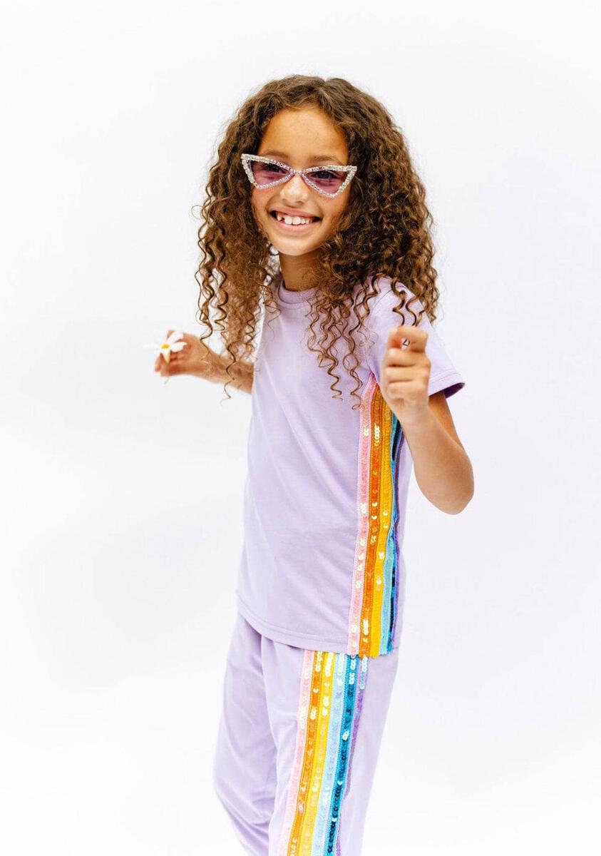 Lola + The Boys Lavender Rainbow Sequin Jogger Set. Dazzle them with this comfy and stylish set that will have them ready to take on the day in a trendy look. Includes soft, lightweight lavender tee and jogger with sequin rainbow aligning the sides. An easy go-to outfit that's sure to bring a smile and some serious sparkle!
