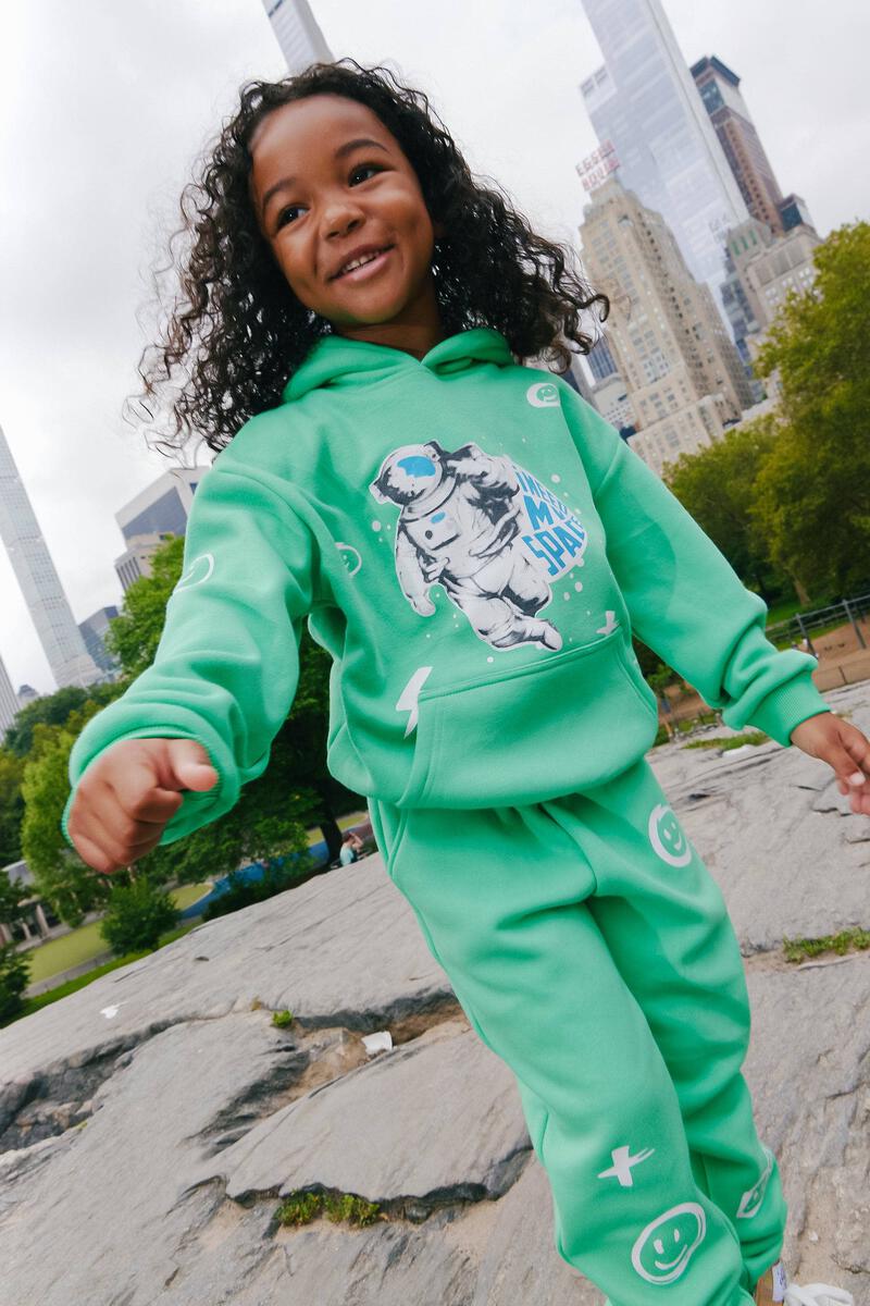 Out of this world in our Lola + The Boys I Need Space Trackset! Includes a cozy fleece green hoodie and matching space-themed jogger.  100% Cotton. Machine washable. Tumble dry low.