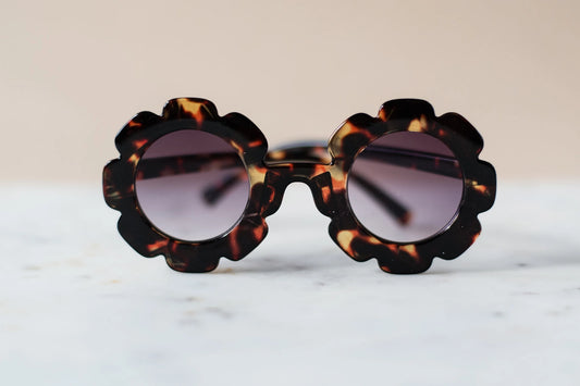 Daisy Amber Tortoise Sunglasses. This stylish design make these sunglasses a fun accessory for any child. Lightweight and comfortable to wear.   100% UV protection.  Women Owned. 