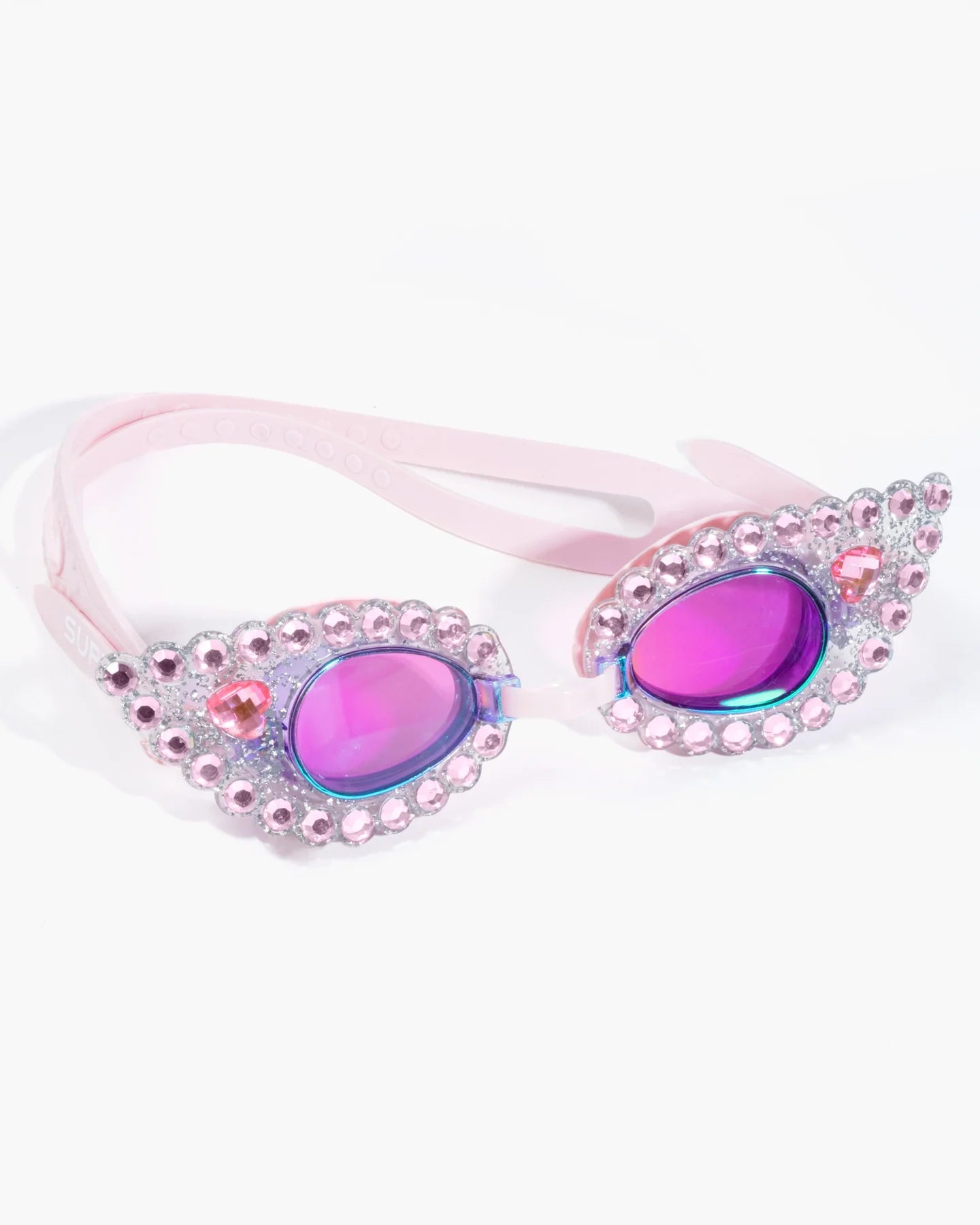 No more sitting pretty poolside, our Super Smalls Pink Splash Goggles will take your swim skills and sparkly style underwater! Our best-selling kid's goggles feature glittery frames covered in pink gems, plus SUPER cool iridescent lenses for the ultimate vacation statement. With it's UV protection lens, watertight seal and a comfy adjustable strap, you’ll be ready to make a SPLASH.  *Small parts, not intended for children under 3 years.
