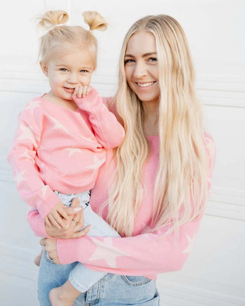 Sweater GOALS! We cannot get over these cute Pink Star Sweaters (also available in Adult!). They are equal amounts of soft and in style - providing you with everything your need to cozy up this season. Pair them with your favorite denim or wear to match with your little!   100% Acrylic.  Machine washable, delicate cycle. 