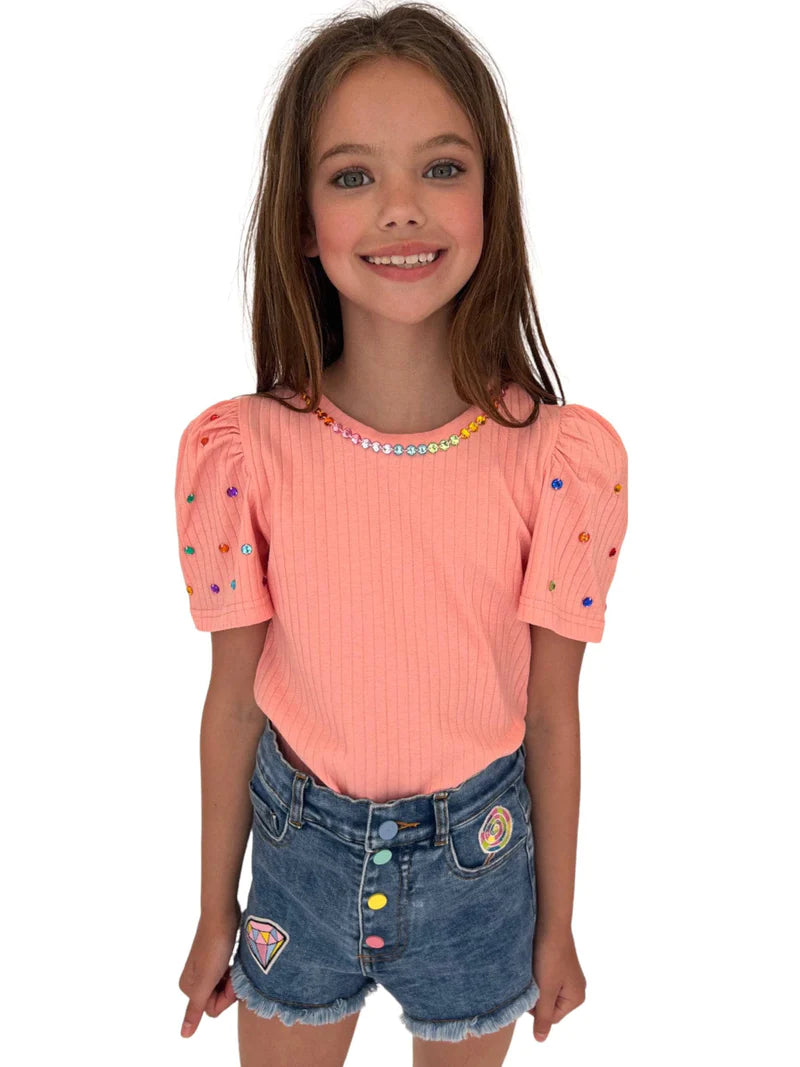 This Lola + The Boys Queen Gem Short Sleeve Tee is an easy elevated basic! Features a peach short puff-sleeved top adorned with rainbow crystal gems.    100% Cotton. Machine washable. Tumble dry low. 