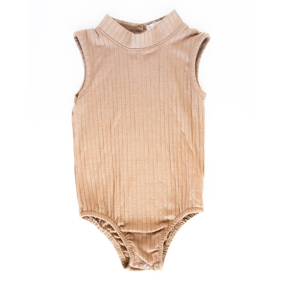Your favorite Maple High Neck Ribbed Bodysuit is back! With a high neck and a ribbed fabric, it's a go-to layer all year. Pair it with a cute mini skirt or a pair of our bell bottoms to really make a statement this season! 93% Rayon, 7% Spandex.  Machine Wash Cold, Lay Flat To Dry.  Women Owned.